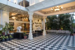 a lobby of a mall with a checkered floor at Raghu Mahal Hotel in Udaipur