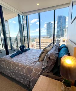 a large bed in a room with a large window at Luxury 1 Bedroom Apartment in Adelaide CBD - 1 minute walk to Rundle mall - Free Wifi & Netflix in Adelaide