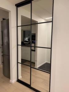 a glass shelf in a room with a refrigerator at Villa Valjensa in Sölvesborg +13 photos