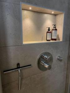 a bathroom with a mirror and two bottles of soap at Villa Valjensa in Sölvesborg