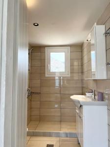 a bathroom with a shower and a sink at Elounda Port Apartment in Elounda
