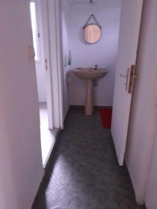 a hallway of a bathroom with a sink and a sink at Maison La voûte plage à 50m et rivière à proximité in Vieux-Habitants