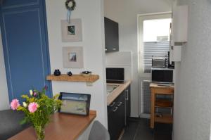 a small kitchen with a table and a counter top at Villa Monika App 7 in Sassnitz