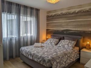 a bedroom with a bed and a large window at Le Bleu Du Lac 3 étoiles - Secteur recherché, Calme & familiale, à 300m du lac & de la vieille ville, Garage privé in Annecy