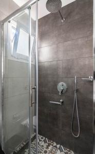 a shower with a glass door in a bathroom at Gazi Home in Athens