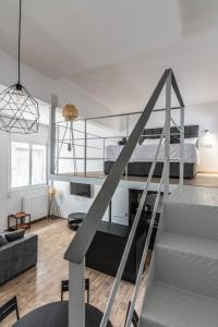 a loft apartment with a staircase and a bed at Gazi Home in Athens