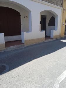 an empty street with two entrances to a building at Casa Martine in Orosei