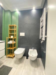 a bathroom with a toilet and a sink at Loft Torlonia in Rome