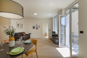 a dining room and living room with a table and chairs at Riviera Flavour Apartments II by Wonderful Italy in Santa Margherita Ligure