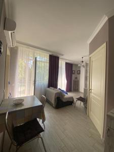 a living room with a bed and a table at 1st line apartment in Kobuleti in K'obulet'i