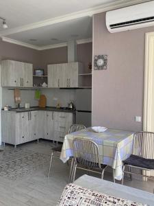 a kitchen and dining room with a table and chairs at 1st line apartment in Kobuleti in K'obulet'i