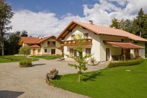 a house with a tree in front of it at Ferienparadies Truppe in Velden am Wörthersee