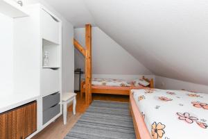 a bedroom with two beds in a attic at Ferienwohnung im Haus Windrose in Wittmund