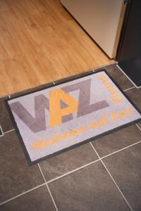 a welcome mat on the floor in front of a door at WAZ Wohnen auf Zeit - Flums in Flums