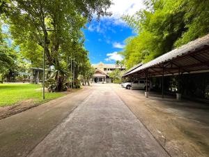 an empty street in front of a house at Rommai Greenpark in Lampang