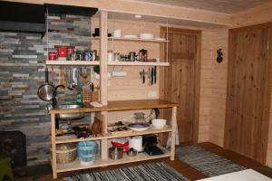 a kitchen with wooden shelves in a room at Natura Sauna in Laulasmaa +10 photos