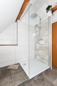 a bathroom with a shower with a glass enclosure at Ferienwohnung im Haus Windrose in Wittmund