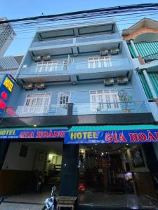 a blue building with a hotel sign in front of it at Gia Hoang Hotel in Quy Nhon