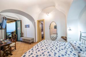 a bedroom with a bed and a mirror at Solaria in Amalfi