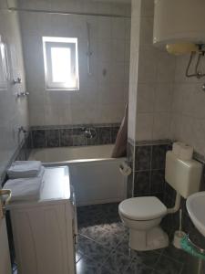 a bathroom with a tub and a toilet and a sink at Apartment Nada in Tučepi