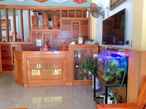 a hotel bar with a fish tank in a room at Gia Hoang Hotel in Quy Nhon