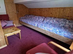 Cette petite chambre comprend un lit et une table. dans l'établissement 2 Zimmer Ferienwohnung Davos-Glaris, à Glaris