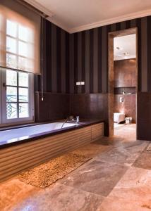 a large bathroom with a tub and a window at The Dudai Titanic Mansion in Savyon