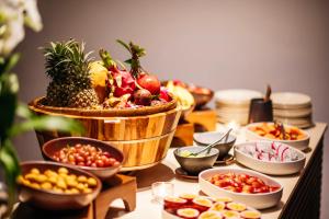 a table topped with bowls of fruits and vegetables at Phulay Bay, A Ritz-Carlton Reserve in Tab Kaek Beach