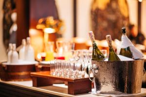 a bucket of wine bottles and glasses on a table at Phulay Bay, A Ritz-Carlton Reserve in Tab Kaek Beach