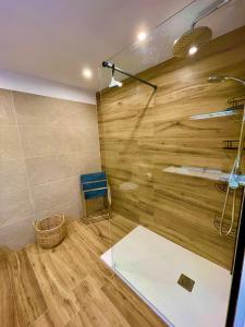 a bathroom with a shower with wooden walls and a sink at SANTA BEACH in Roses +26 photos