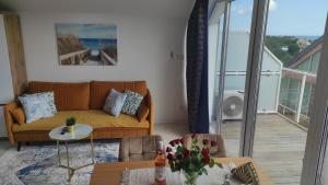 a living room with a couch and a table at Angel Sea Hill Apartment in Mechelinki +45 photos