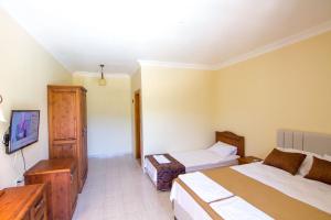 Postel nebo postele na pokoji v ubytování Yeşilkaya Hotel