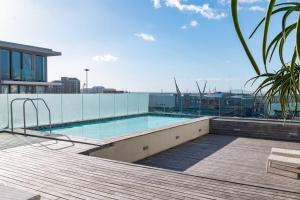 a swimming pool on the roof of a building at Canal-side Serenity in Cape Town