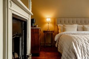 a bedroom with a bed and a table with a lamp at Verandah Cottage B&B 