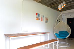 a room with a bench and a blue chair at Kasmarani Homestay in Palembang