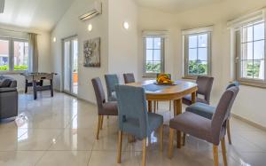 a dining room with a table and chairs at Lotus Villas Resort in Pula