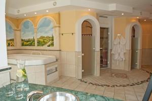 a large bathroom with a tub and a sink at Ferienparadies Truppe in Velden am Wörthersee