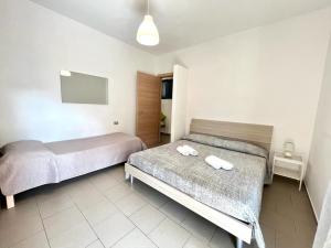 Postel nebo postele na pokoji v ubytování Vittoria Apartament