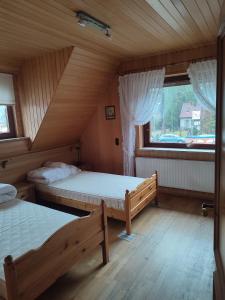 a bedroom with two beds and a window at Appartement am Waldesrand in Gifhorn