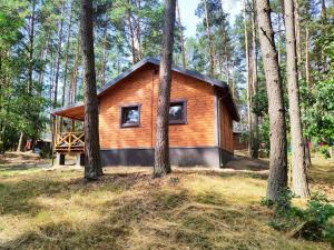 una pequeña cabaña en el bosque con árboles en Lubkowa chata, en Hartowiec