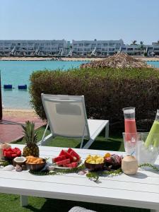 a tray of food on a table next to a beach at Durrat Al Arous - Rose Beach Villas in Durat  Alarous