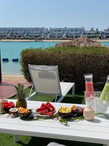 a tray of food on a table next to a beach at Rose Beach Villas in Durat  Alarous