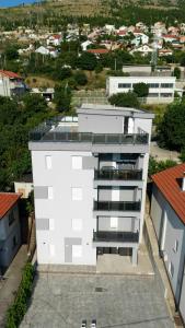 an aerial view of a white building in a city at Villa Scandinavia in Mostar