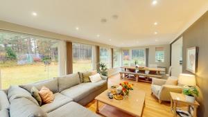 a living room with a couch and a table at Dalnaglar in Nethy Bridge
