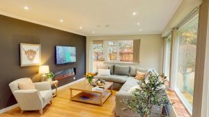 a living room with a couch and a table at Dalnaglar in Nethy Bridge