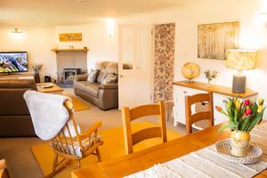 a living room with a couch and a table at Longfield, Daviot in Inverness