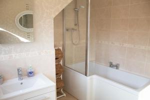 a bathroom with a shower and a tub and a sink at Longfield, Daviot in Inverness +57 photos