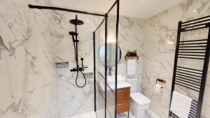 a bathroom with a shower and a toilet and a sink at Dalnaglar in Nethy Bridge +50 photos