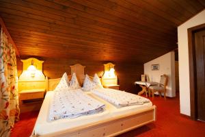 a bedroom with a bed and a wooden ceiling at Almliesl GOLD-706 in Goldegg