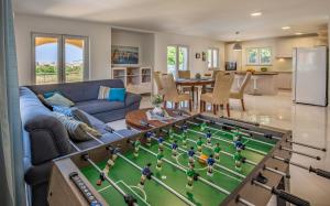 a living room with a table with a foosball at Lotus Villas Resort in Pula
